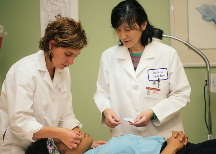 Acupuncture degree program students in practice.